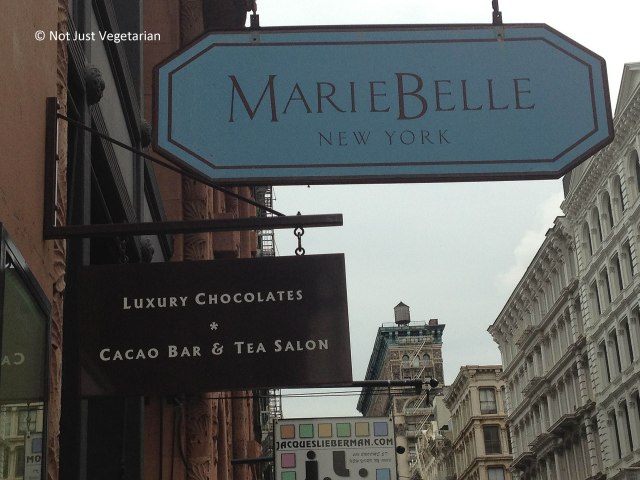Board at entrance to Marie Belle in SoHo, NYC
