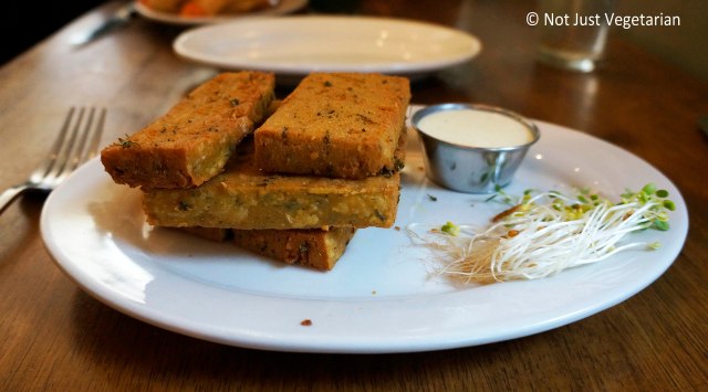 Vegan chickpea fries with Indian spices and a house dipping sauce at Peacefood Cafe NYC