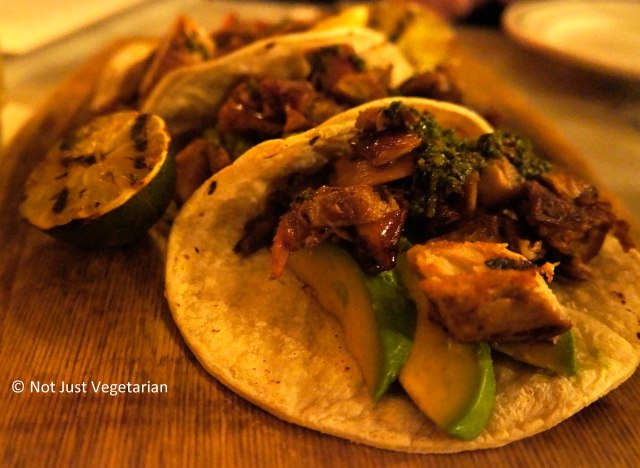 Tacos with suckling pig, fresh sliced avocado and chimichurri sauce at Oficina Latina NYC
