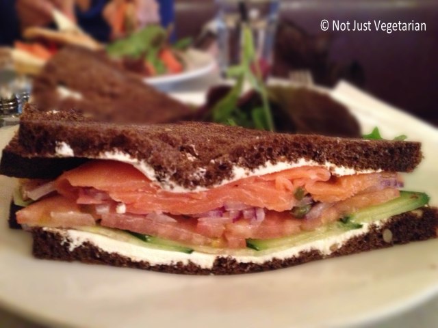 Smoked salmon on pumpernickel bread with cream cheese, cucumber,onions and tomatoes at Cafe Champignon, NYC