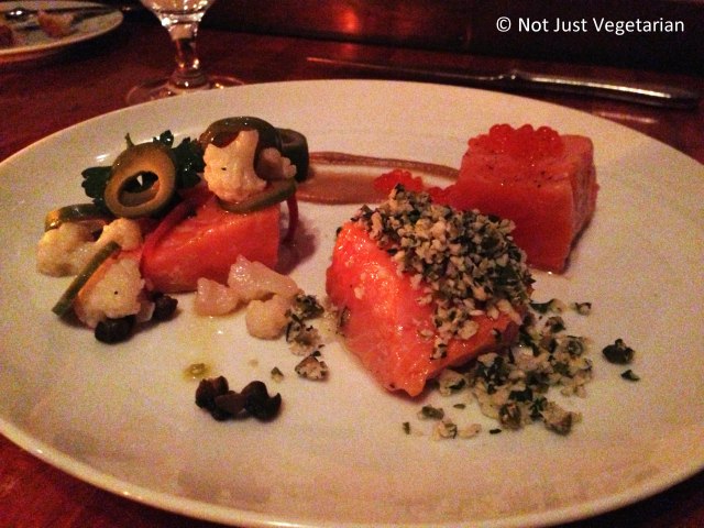 Olive oil poached salmon served with sliced olives and trout roe at Hearth NYC