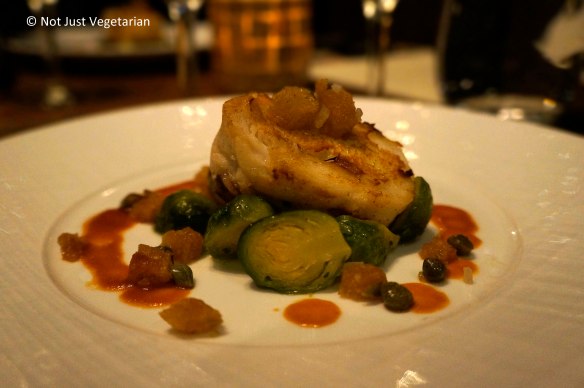 Seared skate wing entree with brussels sprouts fondue, crispy croutons in spicy jus, and capers at Jeanne & Gaston NYC
