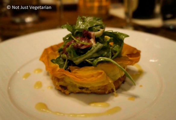 Quiche Boudin Noir (blood sausage) with sauteed apples and a few leaves at Jeanne & Gaston NYC
