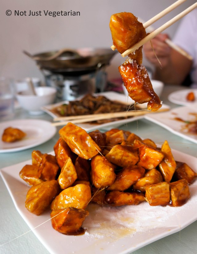 Dessert of sweet potato wedges, apples, and taro coated in corn flour, fried and tossed in hot sticky syrup at Lao Dong Bei in Flushing, NY