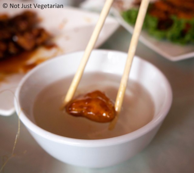 Cooling a piece of dessert in a cup of cool water - at Lao Dong Bei in Flushing, NY