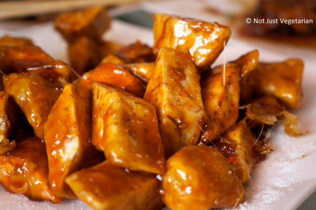 Sticky strands of caramel sticking to the pieces of sweet potatoes, apples, and taro at Lao Dong Bei, Flushing, NY