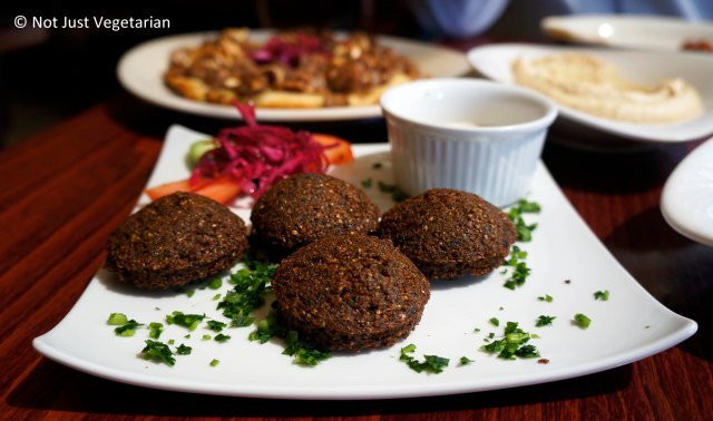 Falafels served with tahini and tomatoes at Tanoreen NYC