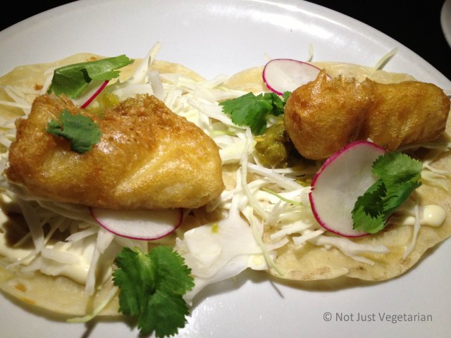 Fish tempura tacos with shredded cabbage and lime mayonnaise and a spicy salsa verde at Empellon Taqueria NYC