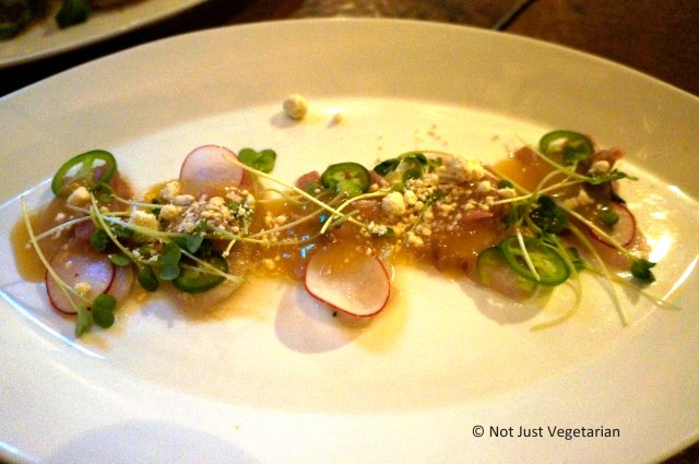 Hamachi crudo with jalapenos, pickled ramps, and sesame powder at Greenwich Project NYC