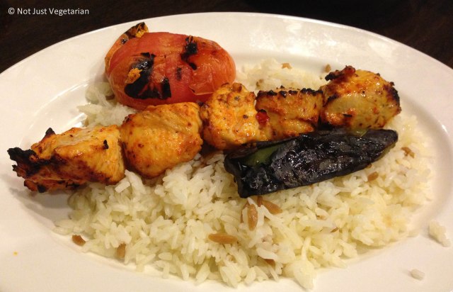 Chicken sheesh kebab with a grilled tomato, a grilled pepper and warm rice at Rumi Turkish Grill in Jersey City
