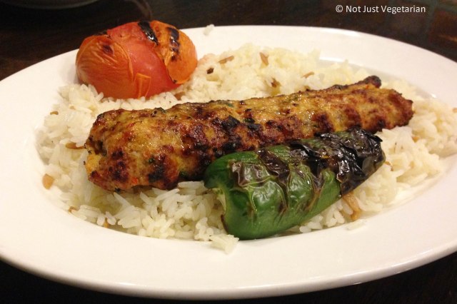 Chicken adana kebab with a grilled tomato, grilled pepper and warm rice at Rumi Turkish Grill in Jersey City