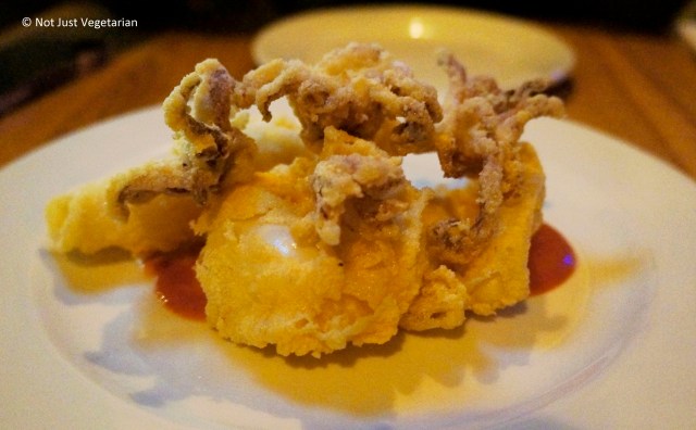 Fried calamari with olives and sun-dried tomato sauce at Goat in Chelsea, London