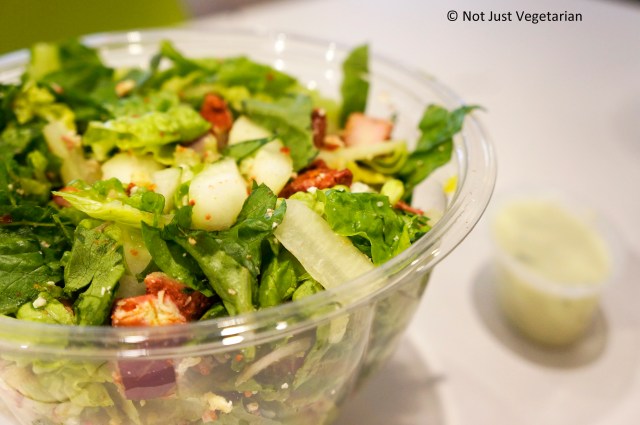 Tandoori Fire Salad (tandoori chicken, pita chips, feta cheese, seedless cucumbers, red onions, and romaine) at Just Salad NYC