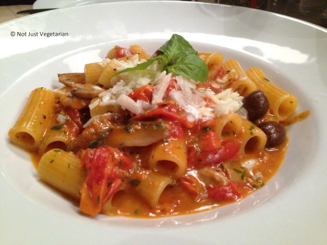 Cacciatora - rigatoni pasta with chicken, mushrooms, olives and pecorino cheese in a cherry tomato sauce - at Rossopomodoro on Fulham Road, London