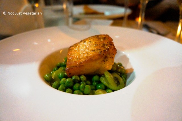 Grilled salmon fillet served on peas and fava beans at Giano NYC