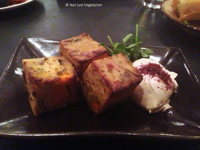 Plantain, feta and sweet potato tortilla with pomegranate labneh and pea shoots at Kopapa in London