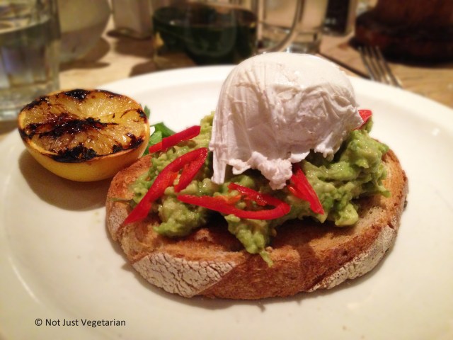 Avocado with fresh red chilli on grilled sourdough topped with poached egg at Annie's Barnes in London