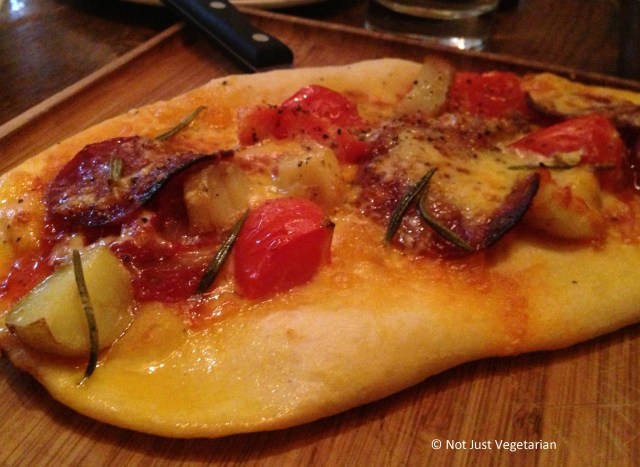 Flat bread with potatoes,  spiced English sausage, cheese and rosemary at Bumpkin, South Kensington in London