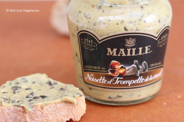 Maille mustard with hazelnut and black chanterelle mushroom on a toasted baguette