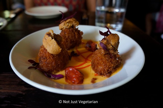 Paella croquetas topped with uni at Casa Mono in NYC