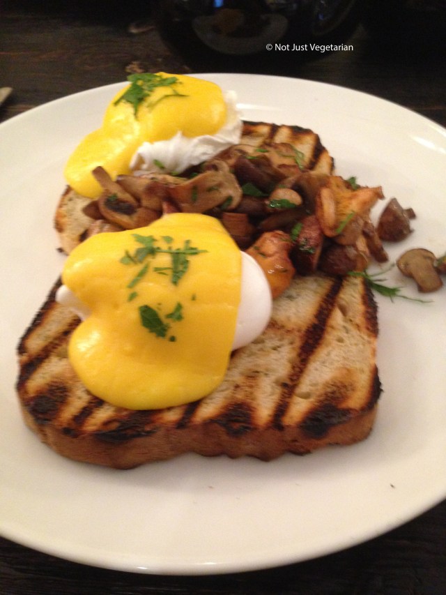 Wild mushrooms and poached eggs on onion bread with Hollandaise sauce at Apero in London